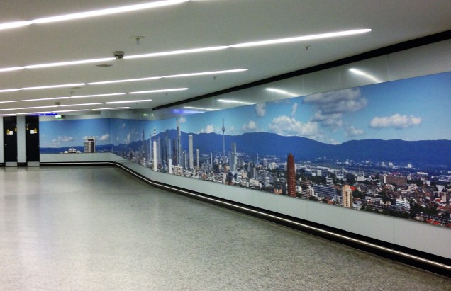 A photo of a hall at Frankfurt Airport with a nice mural of Frankfurt.