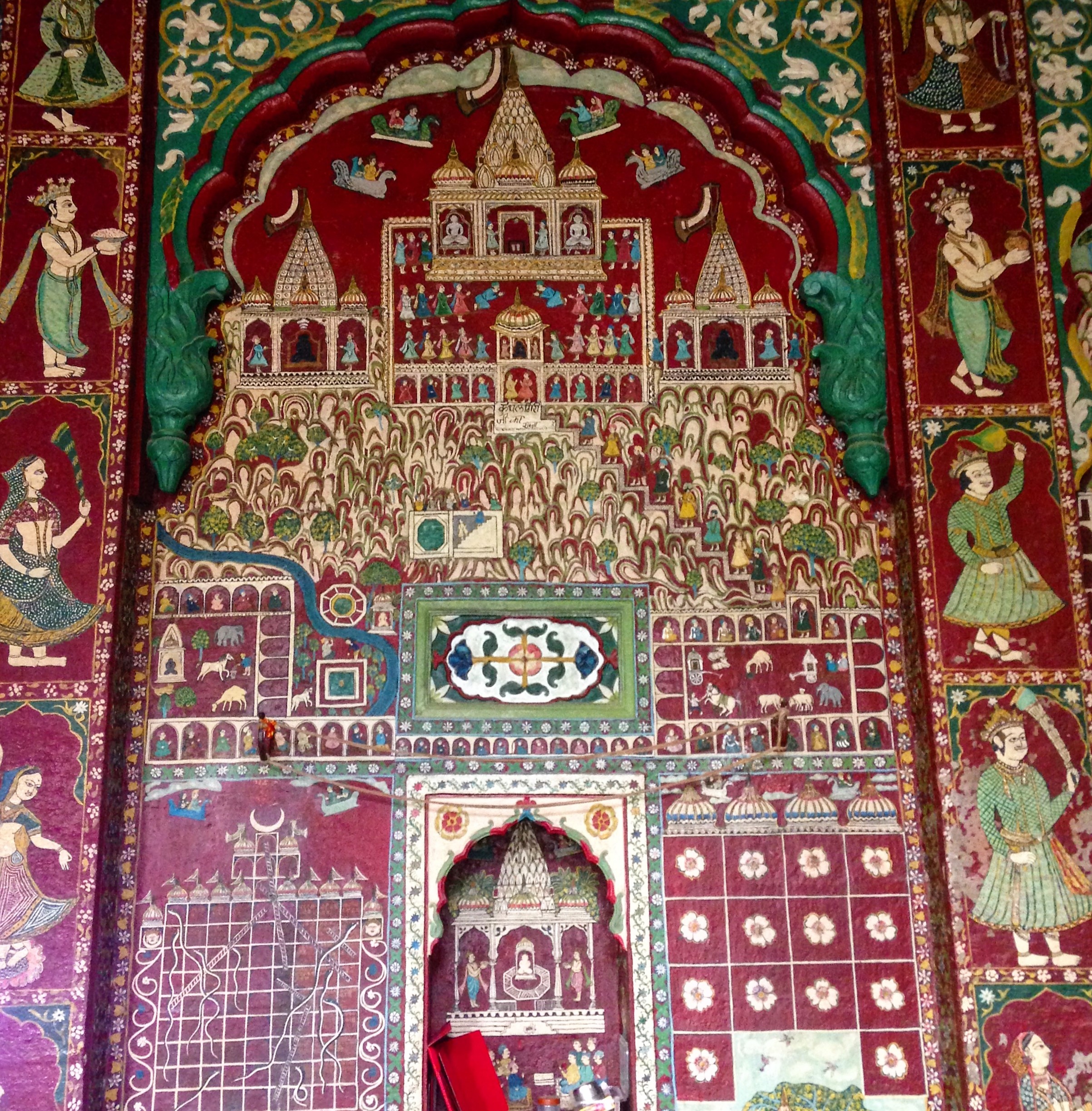 Highly detailed wall mural in the white-and-gold Jain temple, Indore, Madhya Pradesh.