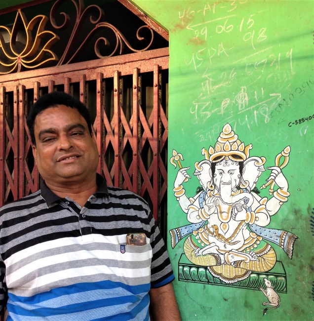 Our new Brahmin friend, pictured with a painting of Ganesh. Puri, Odisha