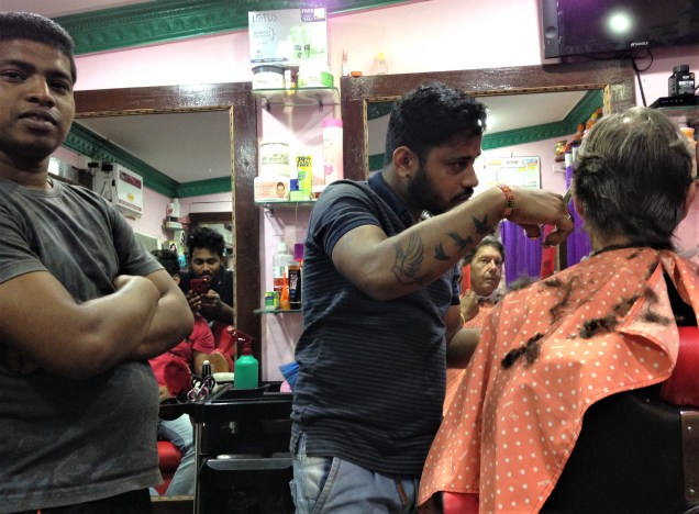 Many of the barber's buddies in barbershop, Puri, Odisha