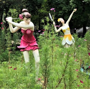 Golf-playing and tennis-playing flower fairies near the Sihuhata statue in 75 Anniversary and Flag Park, Chiang Rai, Thailand